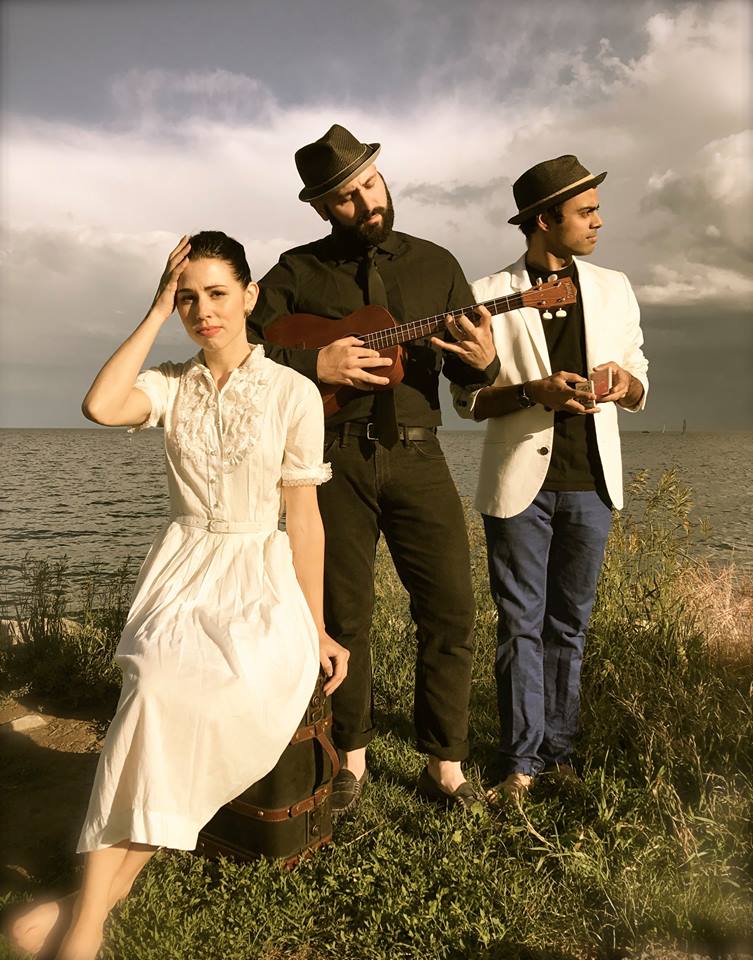 Julia Porter, Chai Lavie, Shawn DeSouza-Coelho pose in a field.