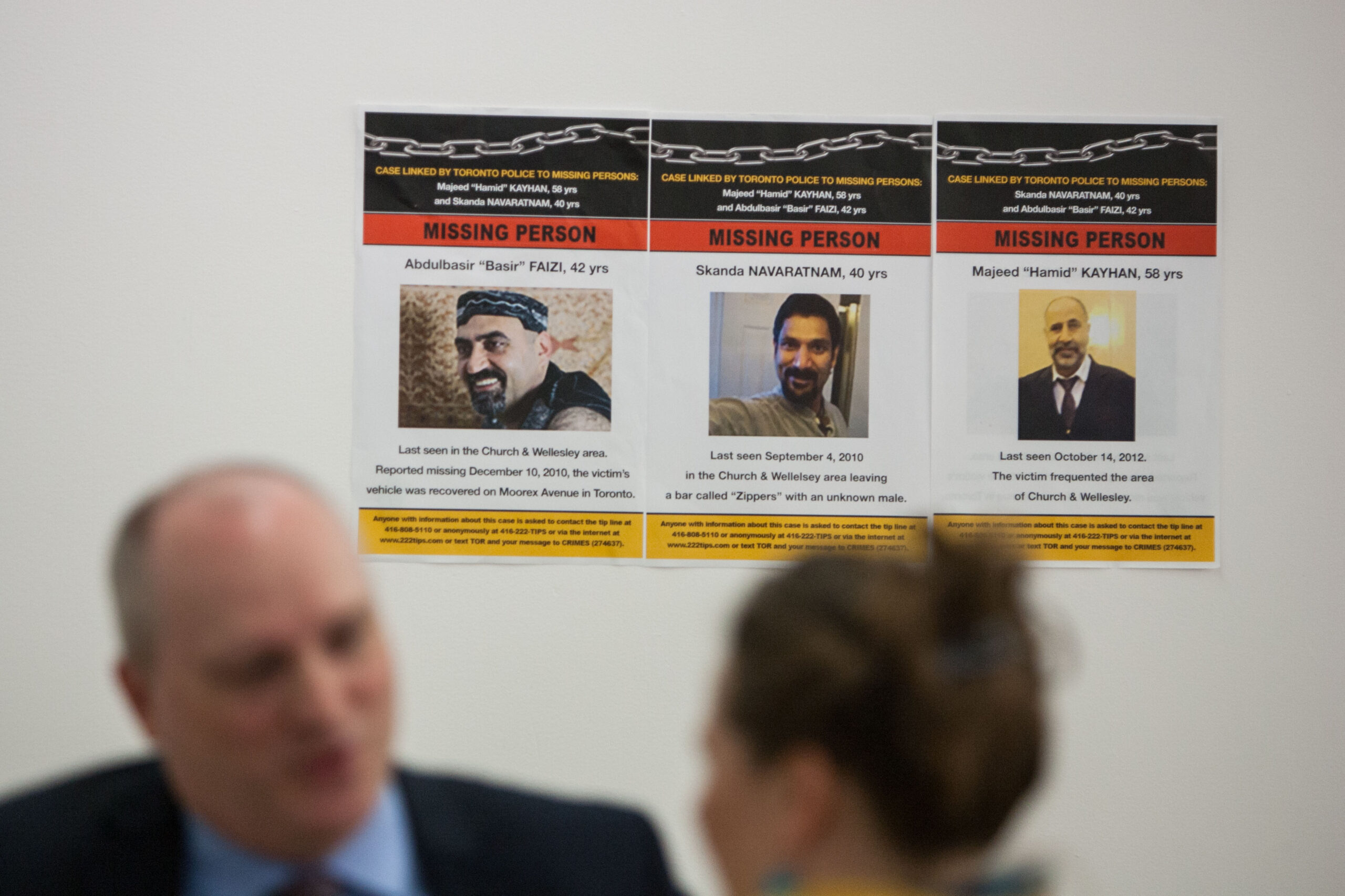 Posters of missing men Abdulbasir Faizi, Skandaraj Navaratnam, and Majeed Kayhan were taped to the wall at the town hall meeting at The 519 to discuss the disappearance missing LGBT people including Andrew Kinsman and Selim Essen on Aug 1, 2017.