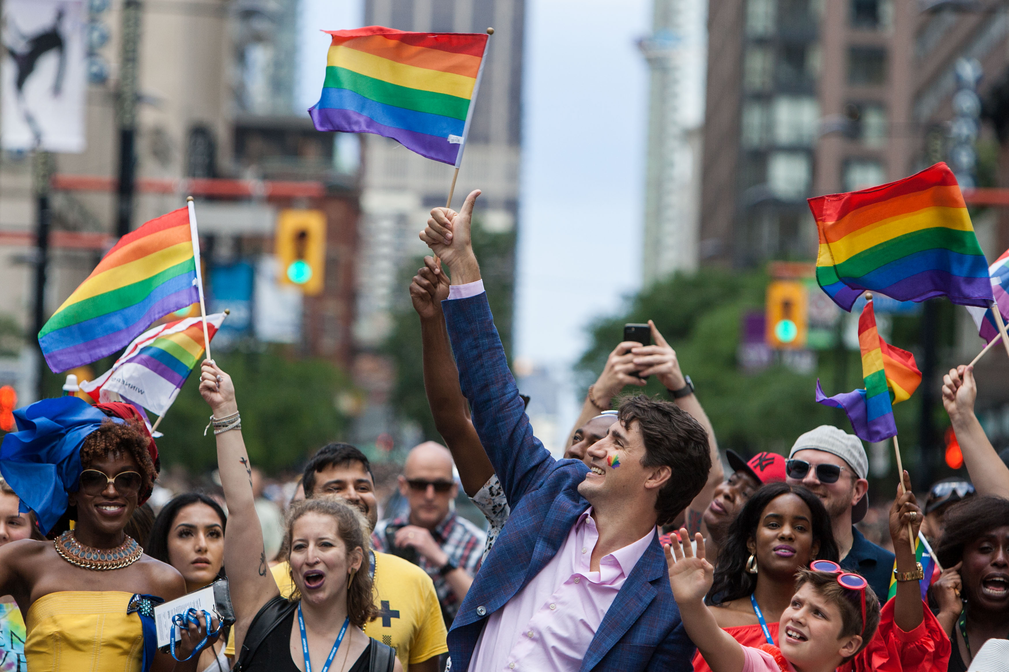 Justin Trudeau gives the crowd a thumbs-up among participants waving rainbow flags at Pride Toronto in 2017.