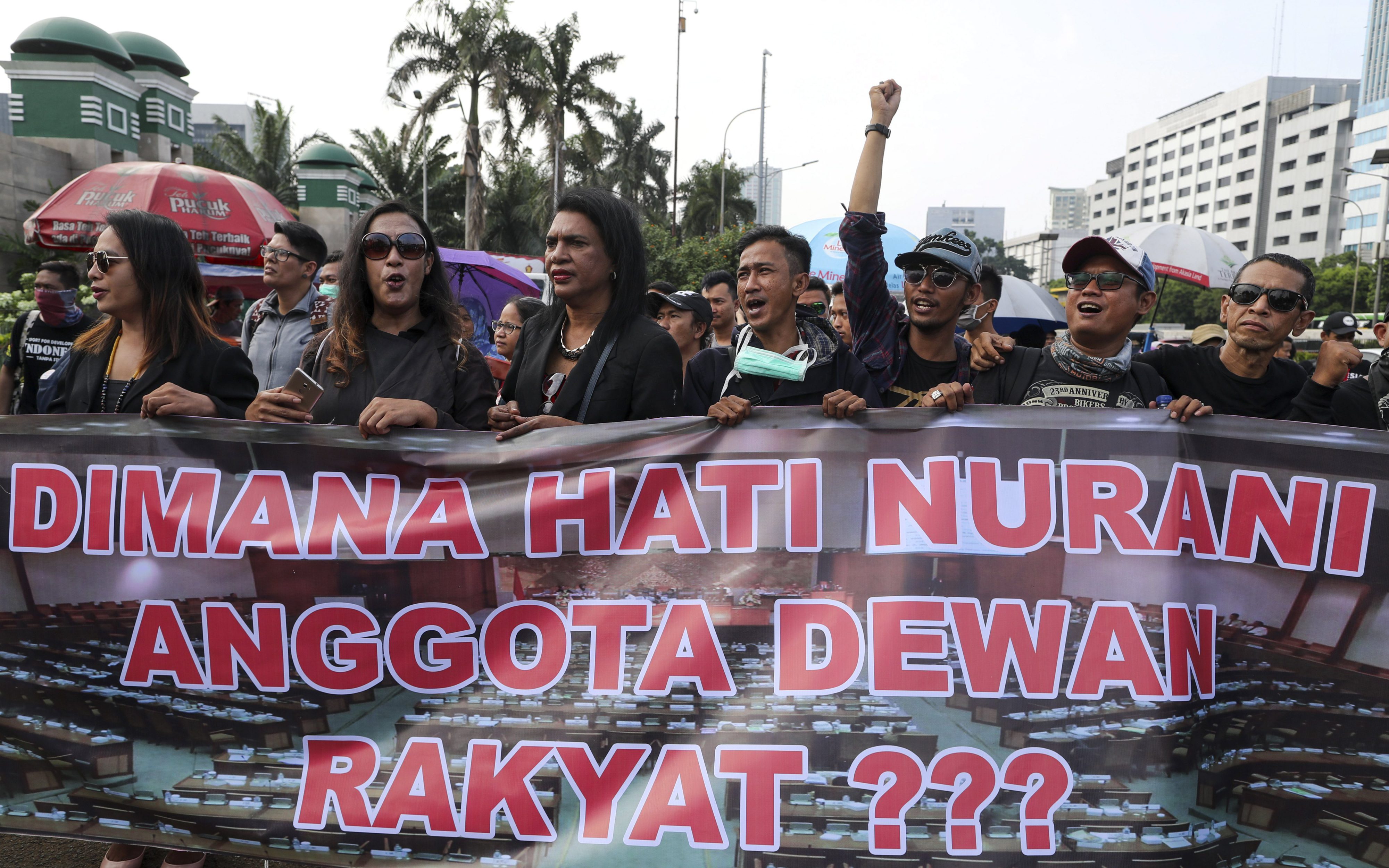 Indonesian LGBT and woman's rights activists protest against proposed changes to the criminal code outside the parliament building in Jakarta, Indonesia, in 2018. 