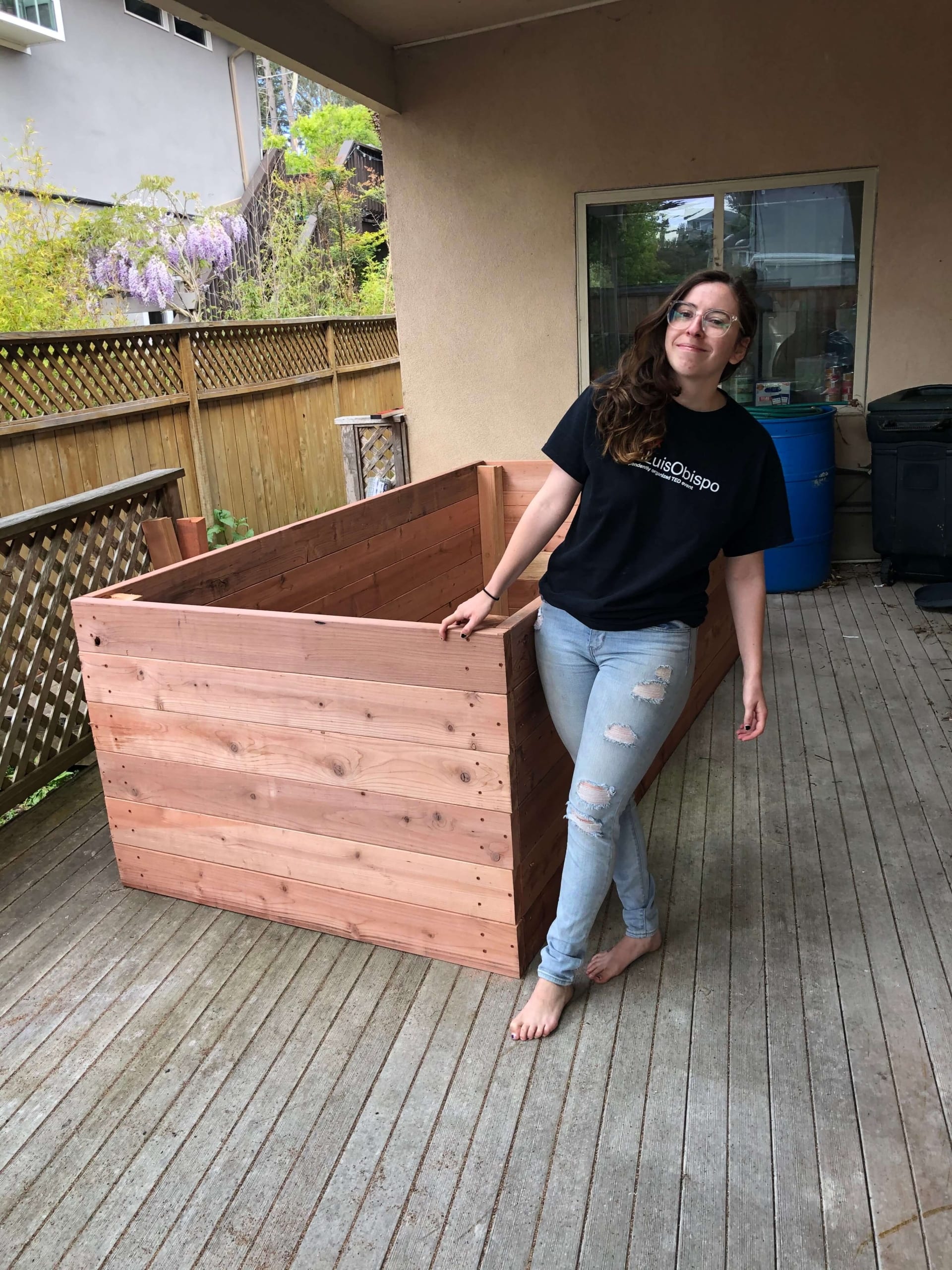The author poses with the garden box she built from scratch during COVID-19 quarantine.