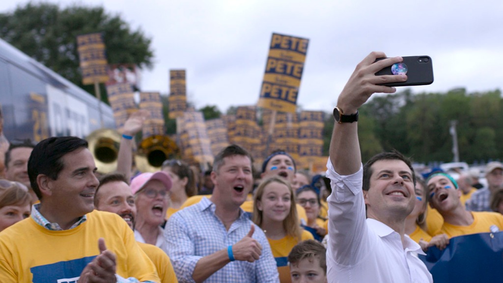 Pete Buttigieg takes a selfie with supporters while on the campaign trail.