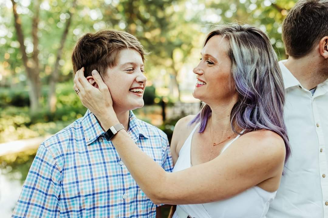 Amber Briggle poses with her child, a hand on his cheek. Briggle is a mother of a trans child concerned about Gov. Greg Abbott’s potential for re-election.