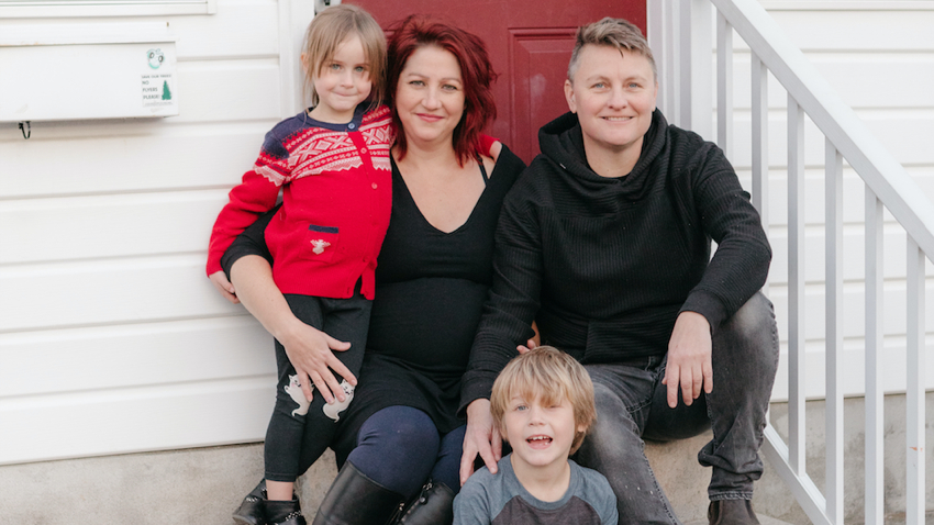 Juliet Donald, co-director of Ads Up Canada, poses with her family on her porch. The family has sponsored five refugees.