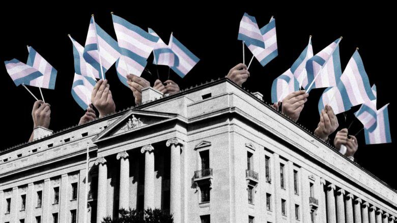 The Justice Dept. building in D.C., with hands carrying trans flags above it.