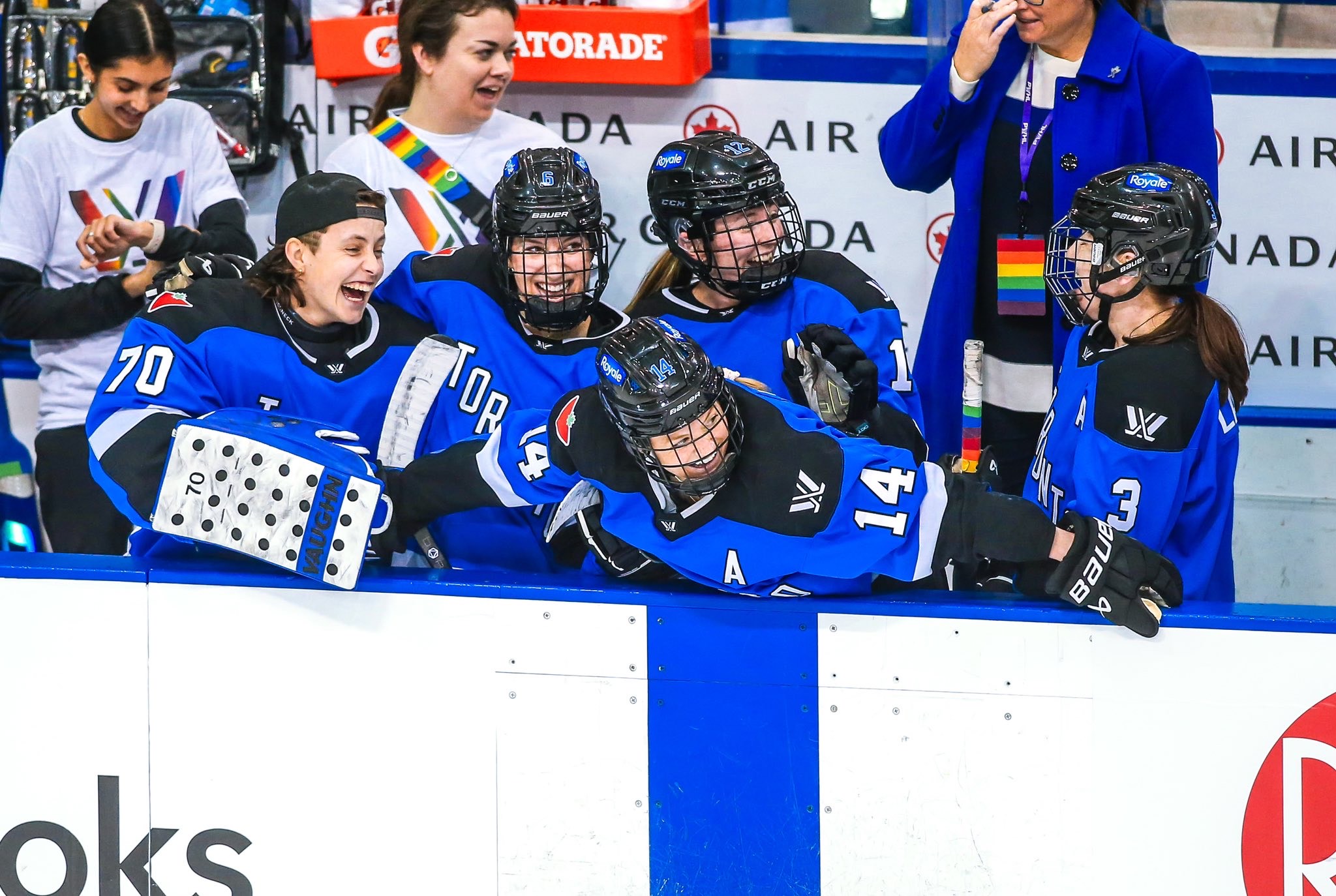 Carly CJ Jackson and their team in hockey uniforms 