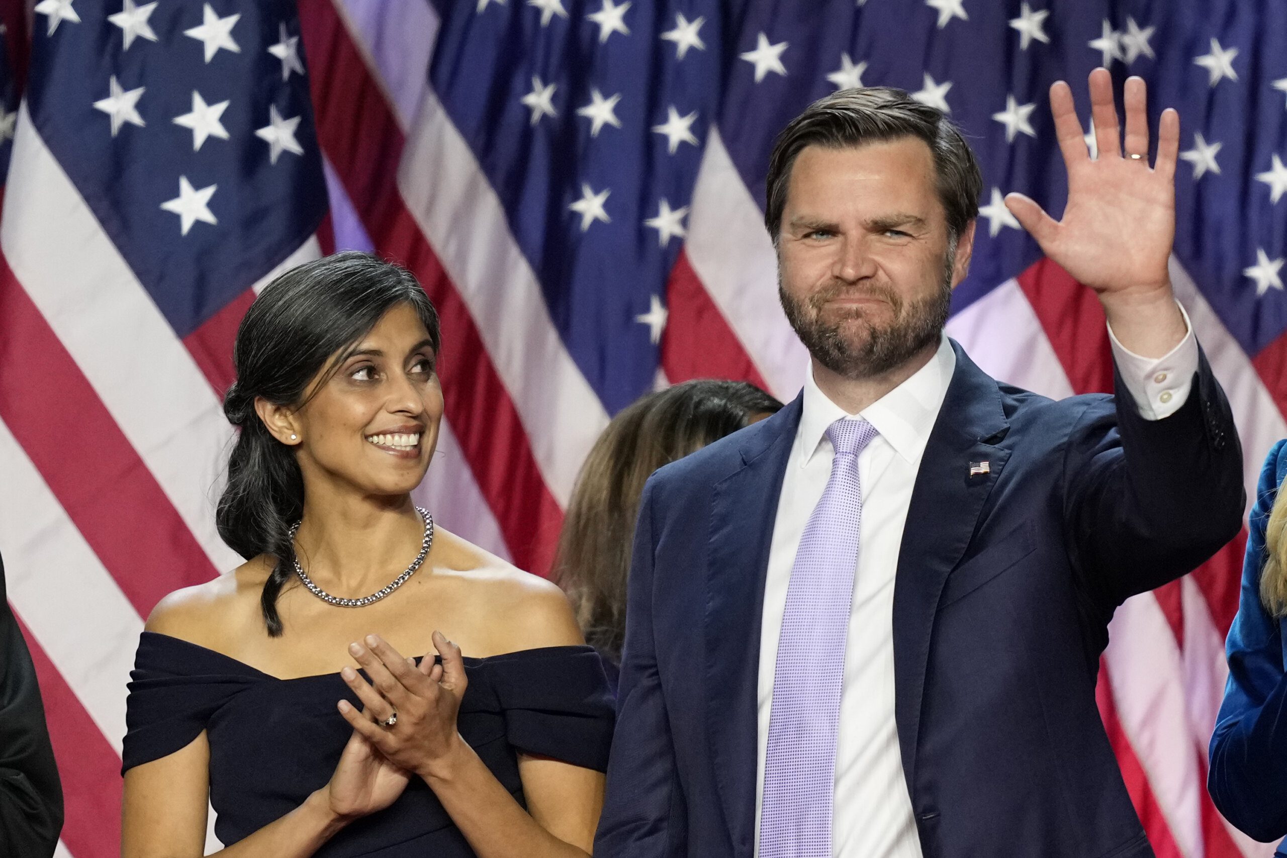 Republican vice presidential nominee Sen. JD Vance, R-Ohio, waves as his wife Usha Vance looks on at an election night watch party.