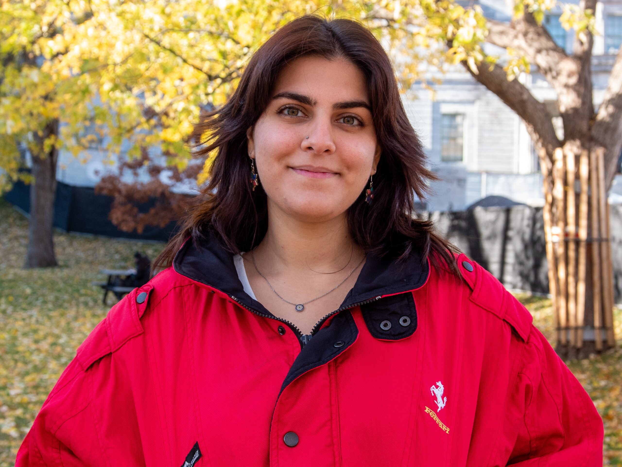 Headshot of Ghazal Azizi in front of a fall outdoor background