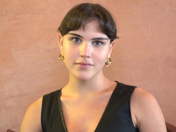 Headshot of Victoria Hincapie Gomez in front of a beige background