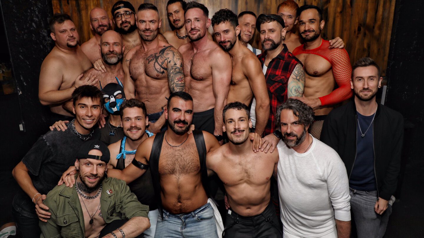 A group of adult content creators connected to the platform Quickies pose in a group. Founder Grant McNaughton appears middle-left.