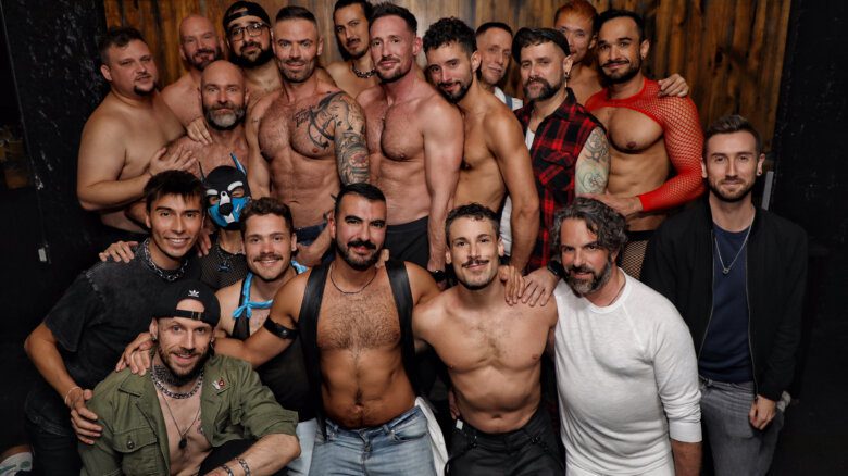 A group of adult content creators connected to the platform Quickies pose in a group. Founder Grant McNaughton appears middle-left.