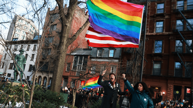 Demonstrators put up an LGBT Pride flag at Stonewall National Monument after it was removed by the Trump Administration