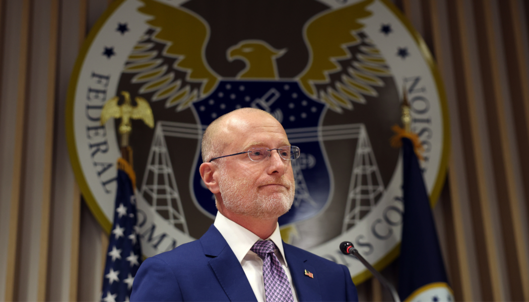 Chairman of the Federal Communications Commission Brendan Carr in front of the FCC logo