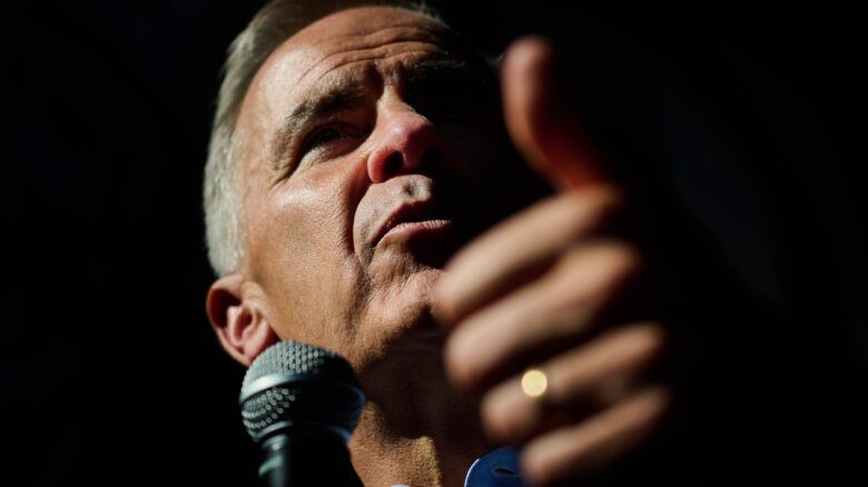A close up of Prime Minister Mark Carney at a microphone giving a thumbs-up.